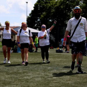 Erzieher:innen der Brenzbären laufen gut gelaunt über den Sportplatz beim Sportfest